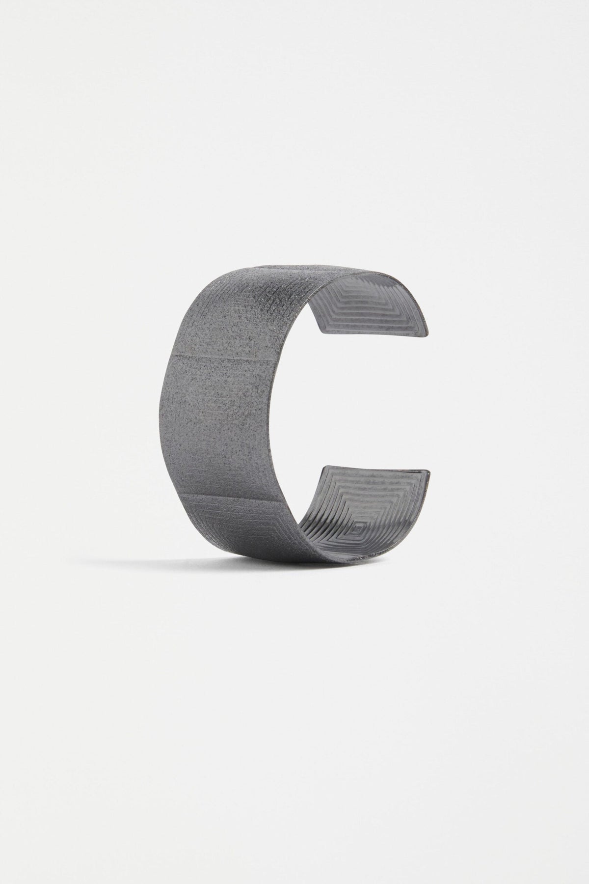 Metri Cuff Bangle with geometric patterns in Gunmetal colour