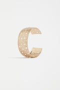 The Hulle Cuff Bangle in Gold - open cuff with varying-sized holes for a unique, artisanal feel.