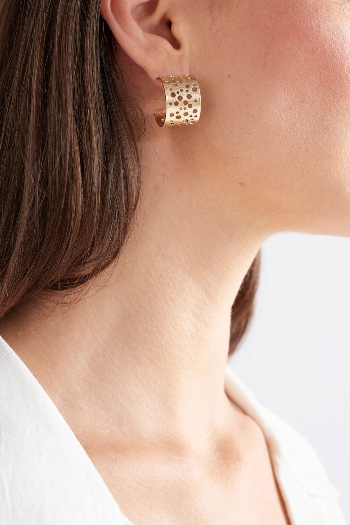 Hulle Tiny Hoop Earring in Gold - textured with unique punched holes
