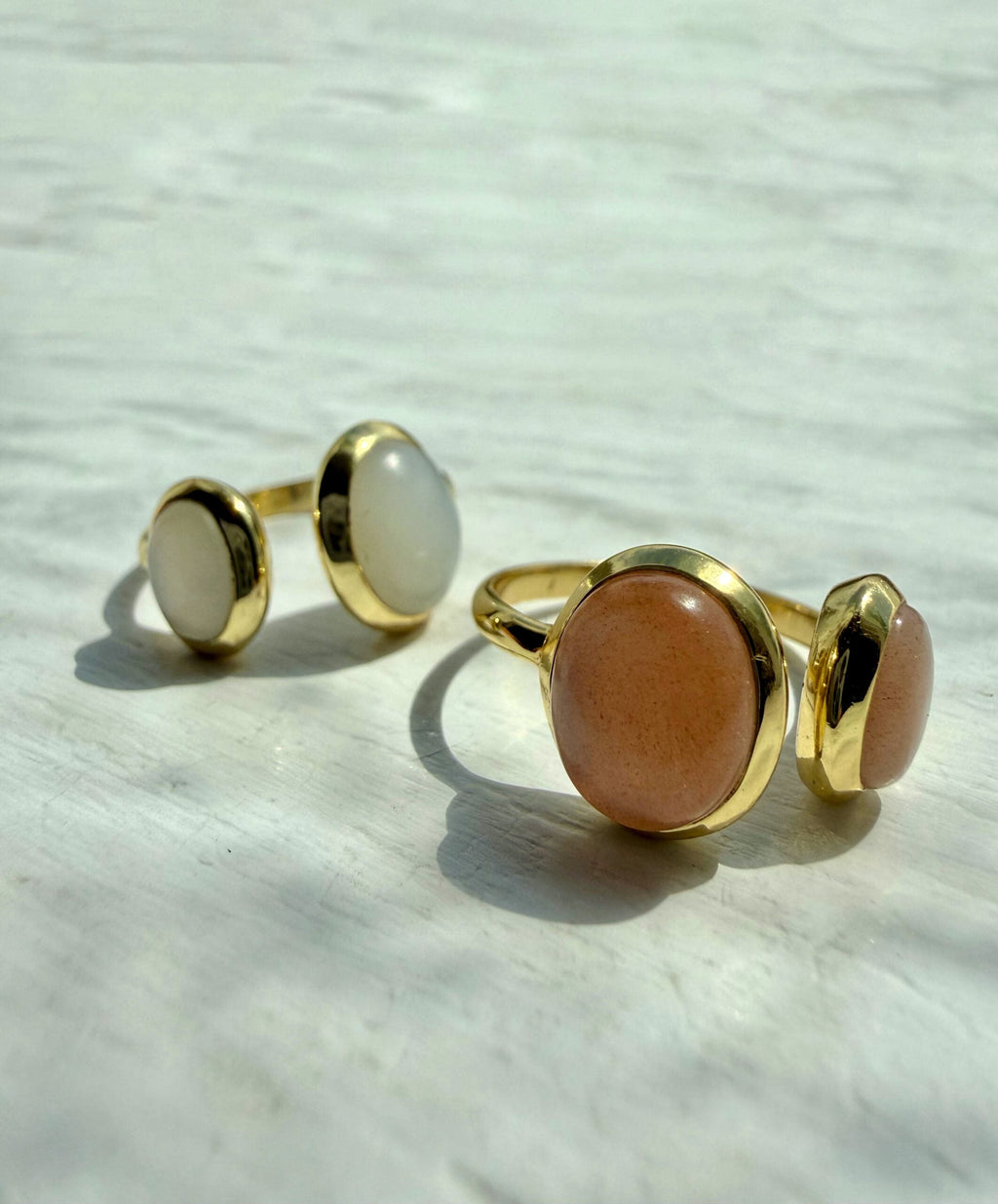 The Double Moonstone Ring features an elegant asymmetric setting with one small and one larger oval moonstone for a modern, sculptural look.