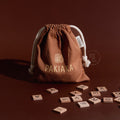 Pakiaka – Te Reo Māori Word Game wooden letter tiles with drawstring bag