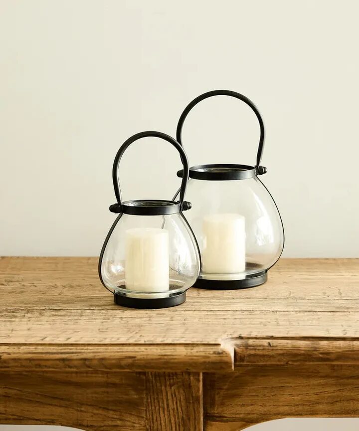 Small bulb shaped table lantern made of glass and iron.