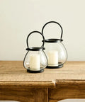 Small bulb shaped table lantern made of glass and iron.