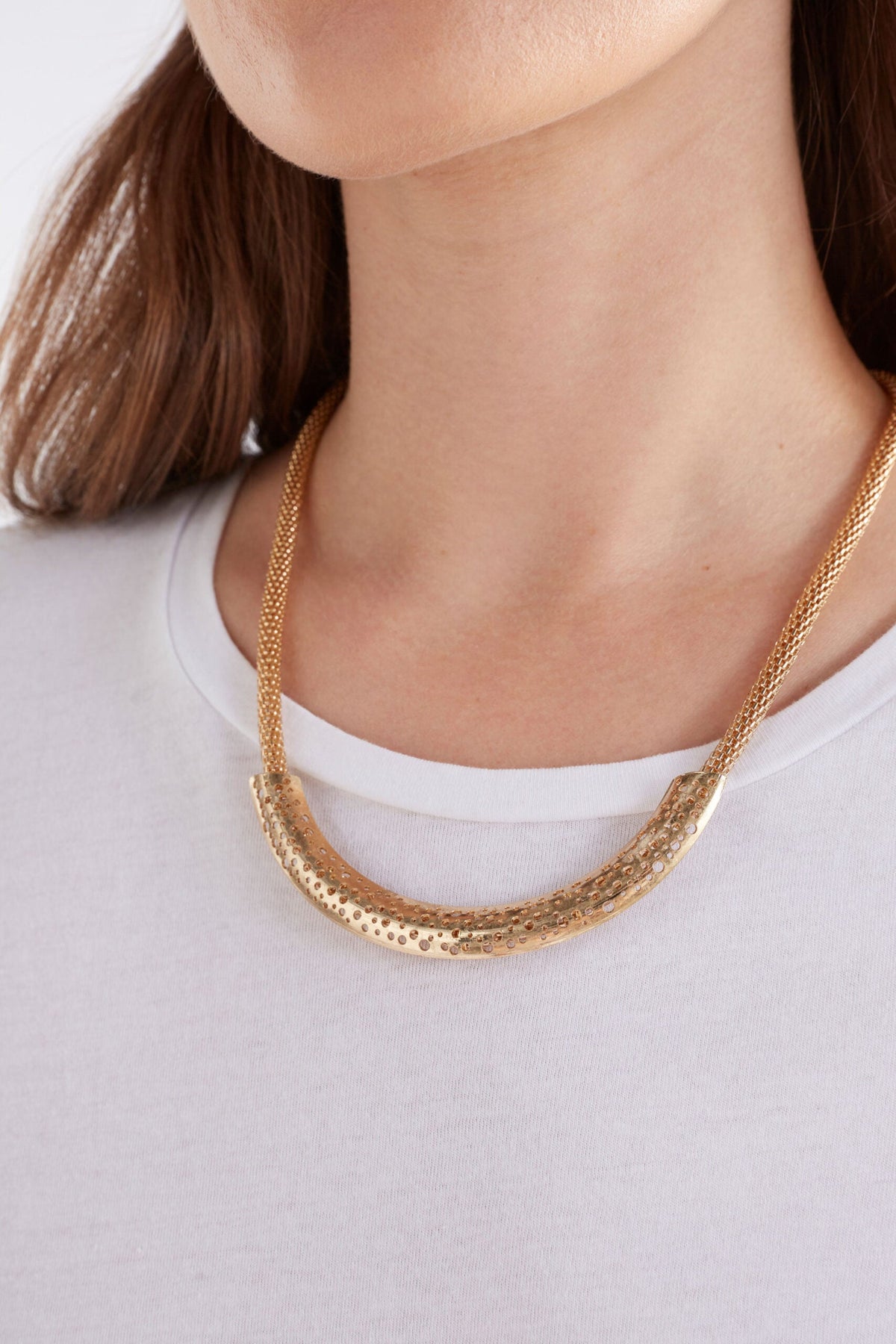 Hulle Necklace in Gold with crescent-shaped worn metal and cut-out details