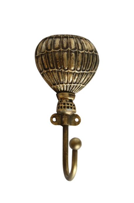 Balloon Hook Brass Finish – a whimsical balloon-shaped wall hook made from pewter with a soft brass finish, mounted on a white wall.
