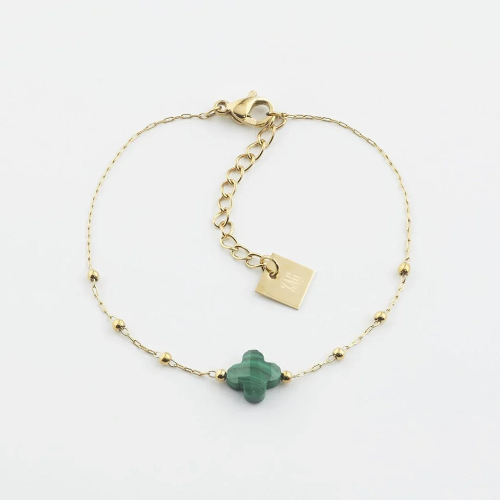 The Velasquez Bracelet is a rosary style bracelet features a fine chain decorated with small gold balls to add style and texture.  A semi-precious stone is faceted in the shape of a clover.