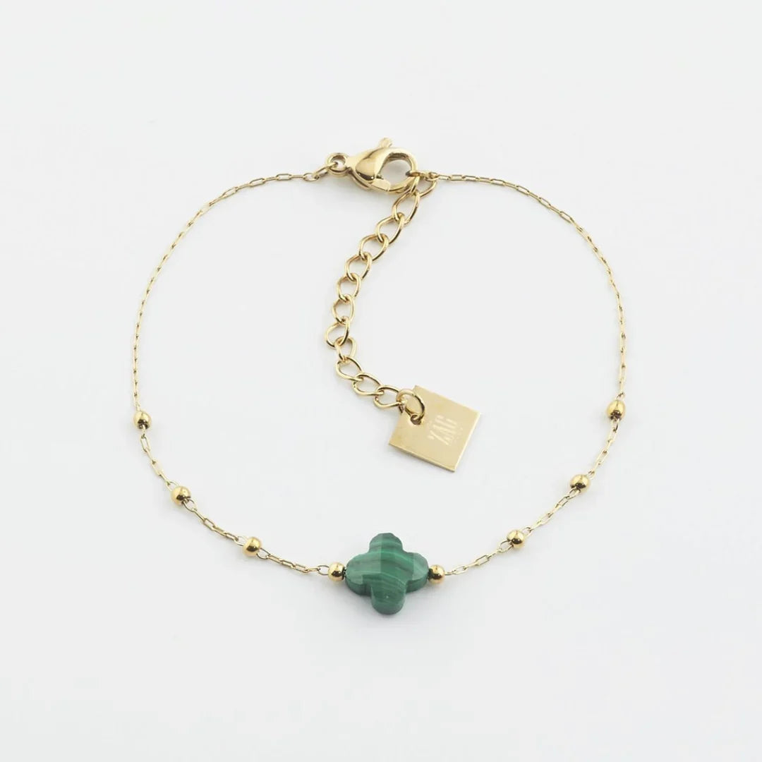 The Velasquez Bracelet is a rosary style bracelet features a fine chain decorated with small gold balls to add style and texture.  A semi-precious stone is faceted in the shape of a clover.